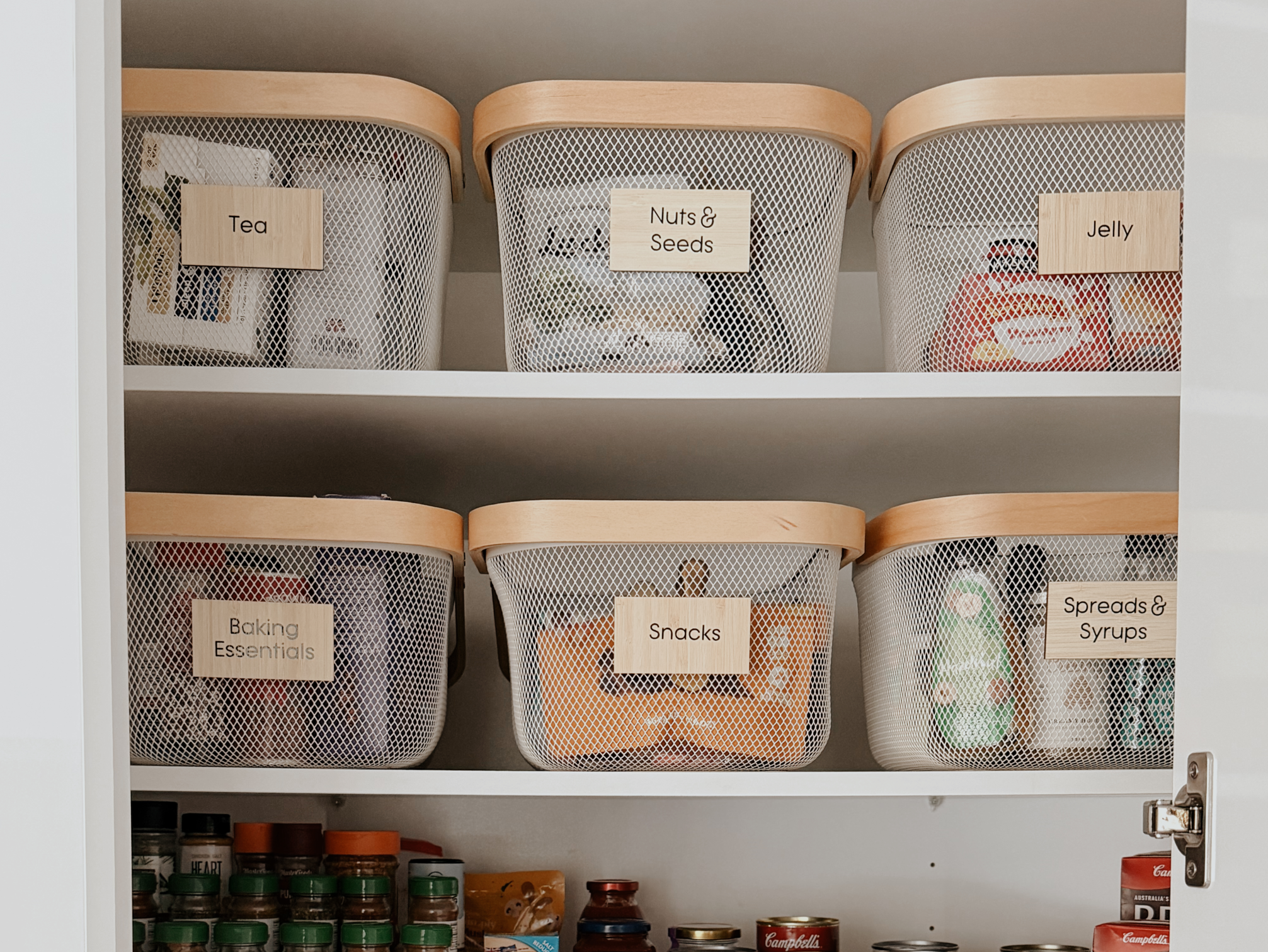 Labelled pantry jars neatly arranged on a shelf